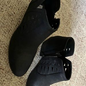 Black boots with decorative cutouts.